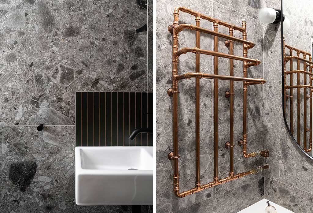 bagno-rivestimento-pietra grigia e-termoarredo-rame-tubi