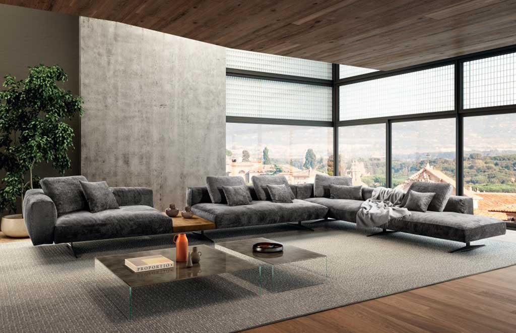 divano angolare tessuto grigio grande con aree appoggio modulari