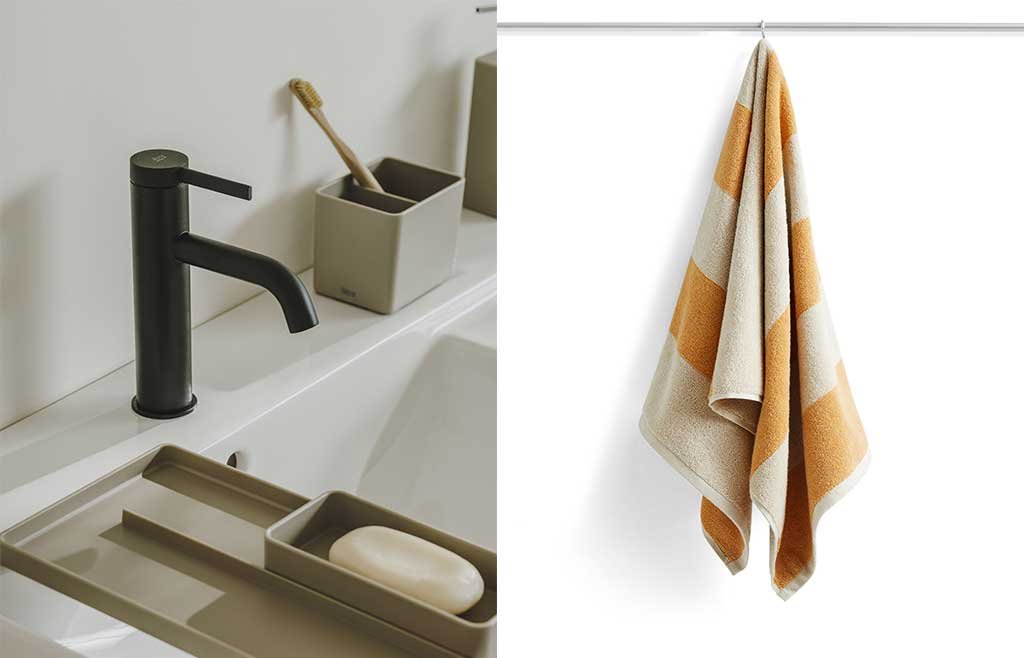 rubinetto bagno nero e asciugamani appeso