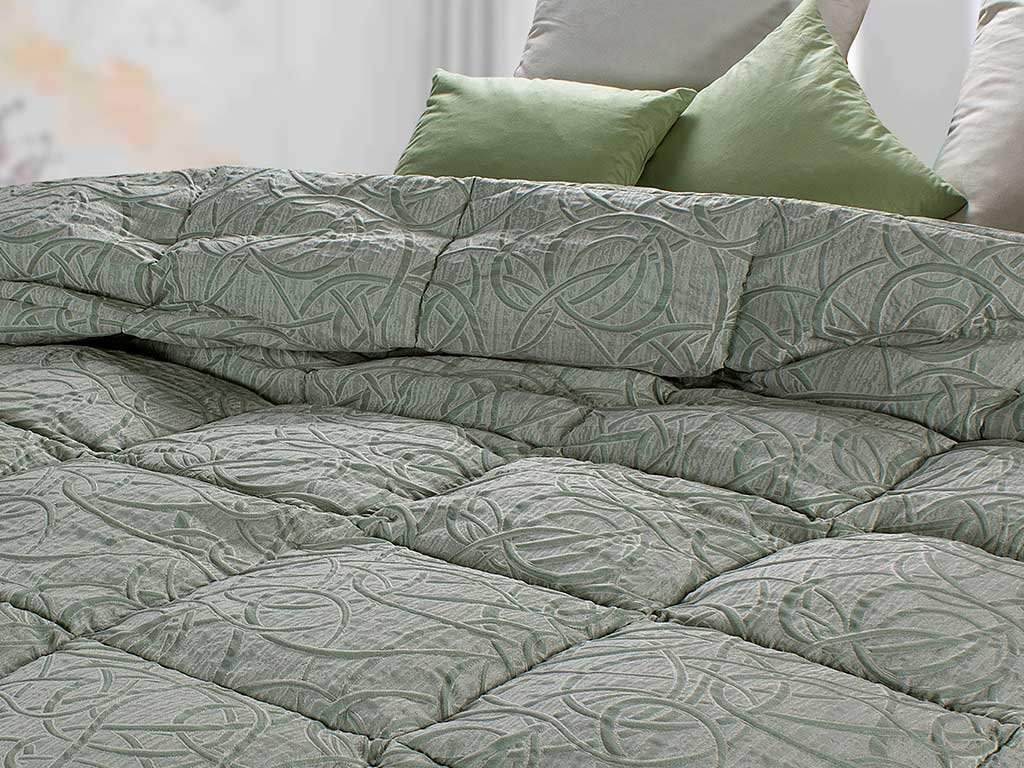 sage colored quilt and relief decorations