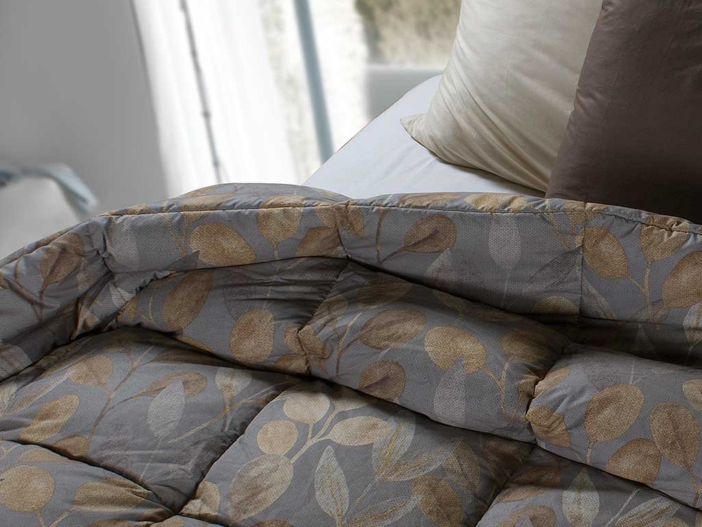 gray quilt and leaf decoration